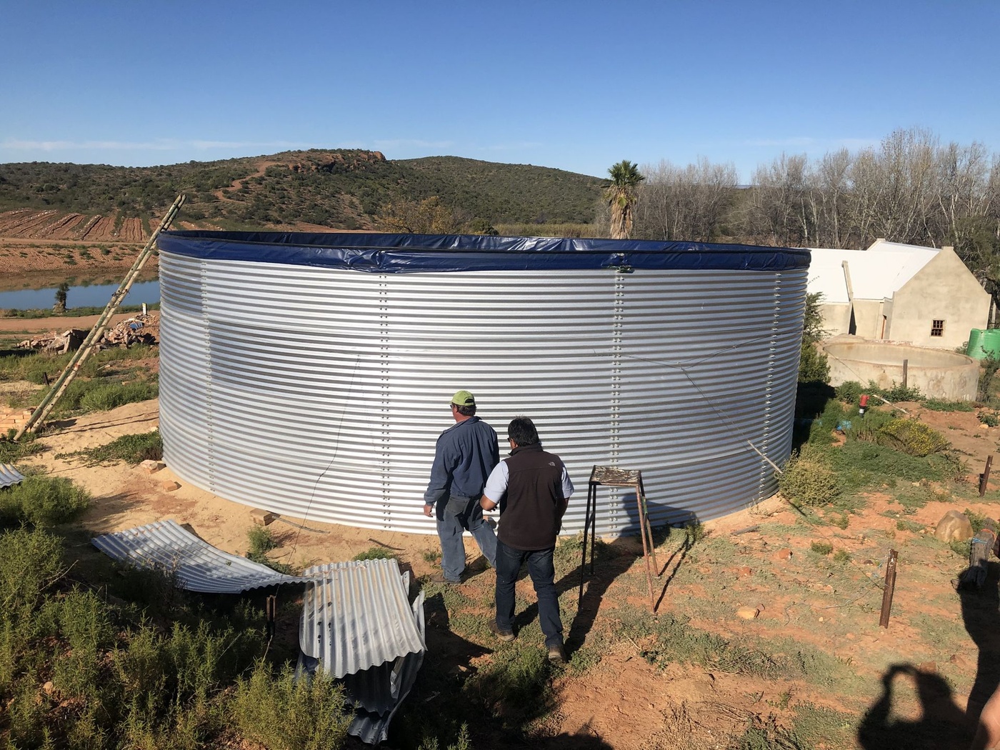 An Aquadam bolted steel tank being erected on a farm as a do-it-yourself installation